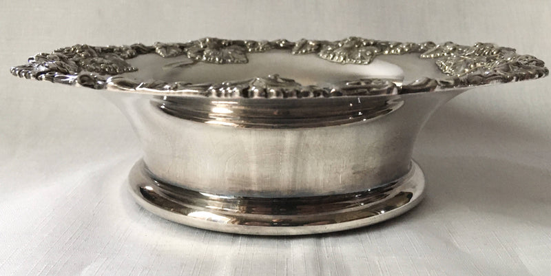 Victorian pair of silver plated bottle coasters with applied rims of trailing vines.