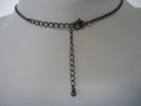 A Vintage Style Necklace with Oval and Round stones in a Circular Setting.