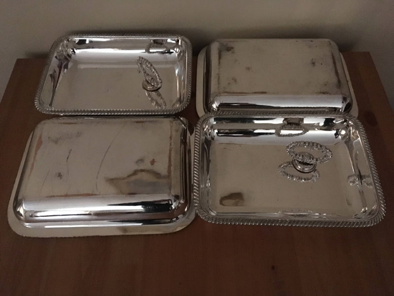 Pair of late Georgian Old Sheffield Plate crested entree dishes with covers and detachable handles.
