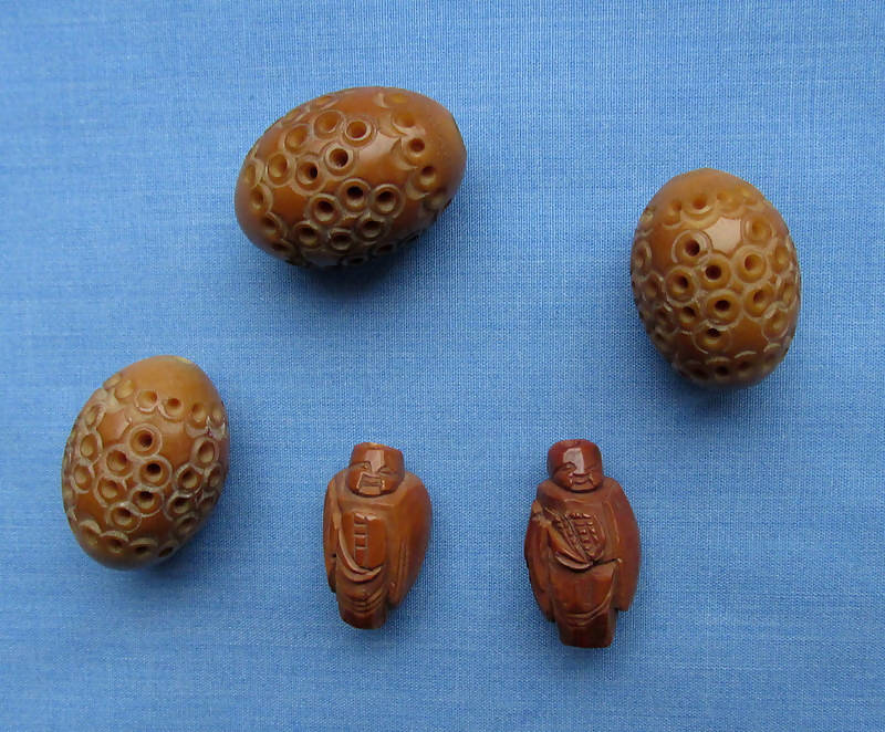 Two Figural Carved Nut Beads Plus Three Vegetable Ivory Beads