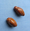 Two Figural Carved Nut Beads Plus Three Vegetable Ivory Beads
