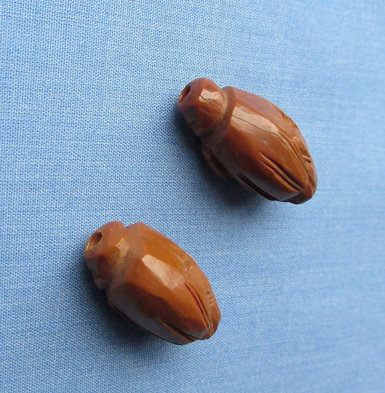 Two Figural Carved Nut Beads Plus Three Vegetable Ivory Beads