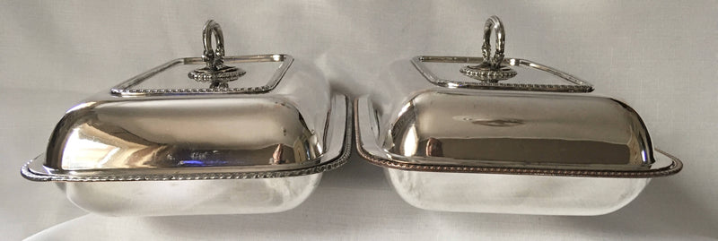 Late Georgian pair of crested, Sheffield Plated, entree dishes and covers, circa 1820 - 1830.