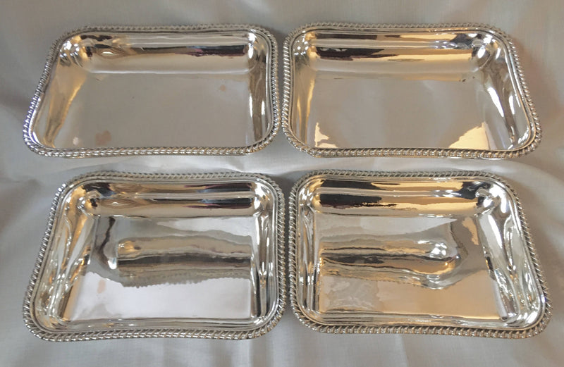 Georgian, George III, set of four Sheffield Plated entree dishes and covers with matching crests. Circa 1810.