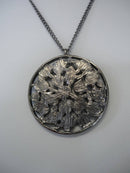 A Vintage Style Necklace with Oval and Round stones in a Circular Setting.