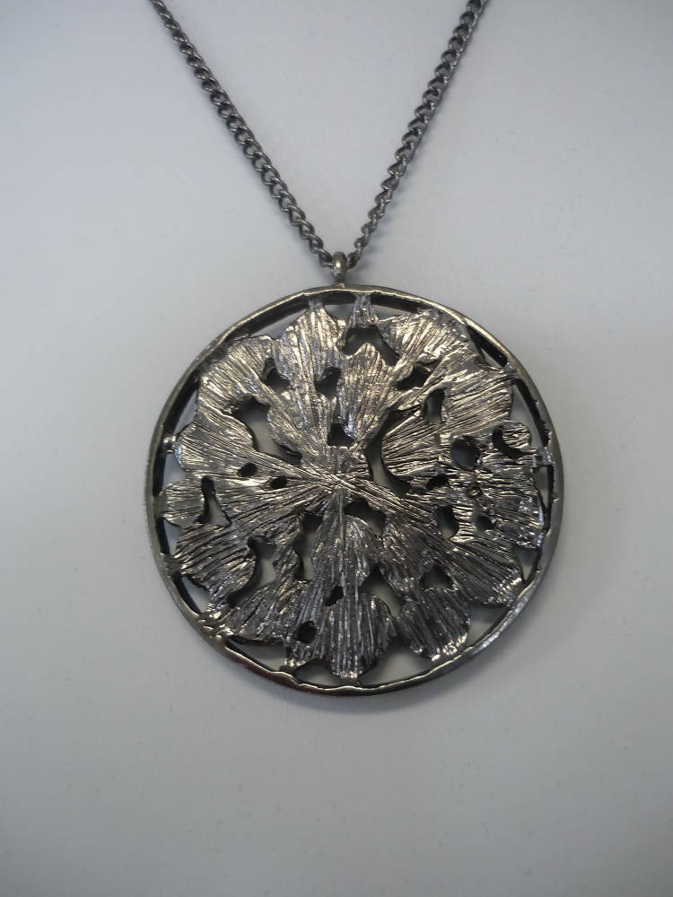 A Vintage Style Necklace with Oval and Round stones in a Circular Setting.
