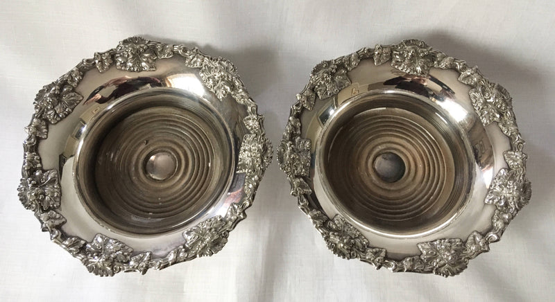 Victorian pair of silver plated bottle coasters with applied rims of trailing vines.