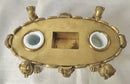 Regency period gilt bronze inkstand raised on lioness paw feet and adorned with ram masks.