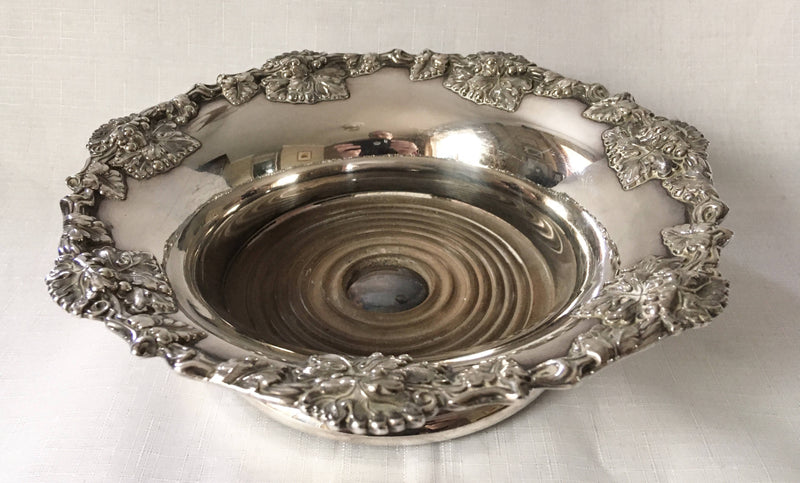 Victorian pair of silver plated bottle coasters with applied rims of trailing vines.