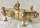 Regency period gilt bronze inkstand raised on lioness paw feet and adorned with ram masks.